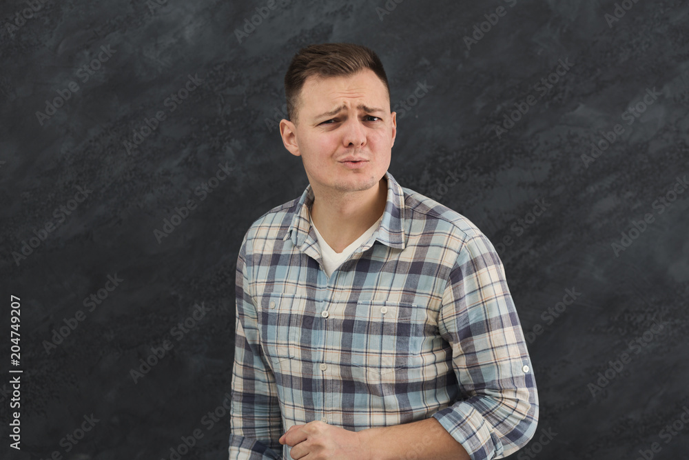 Suspicious young man looks doubtfully