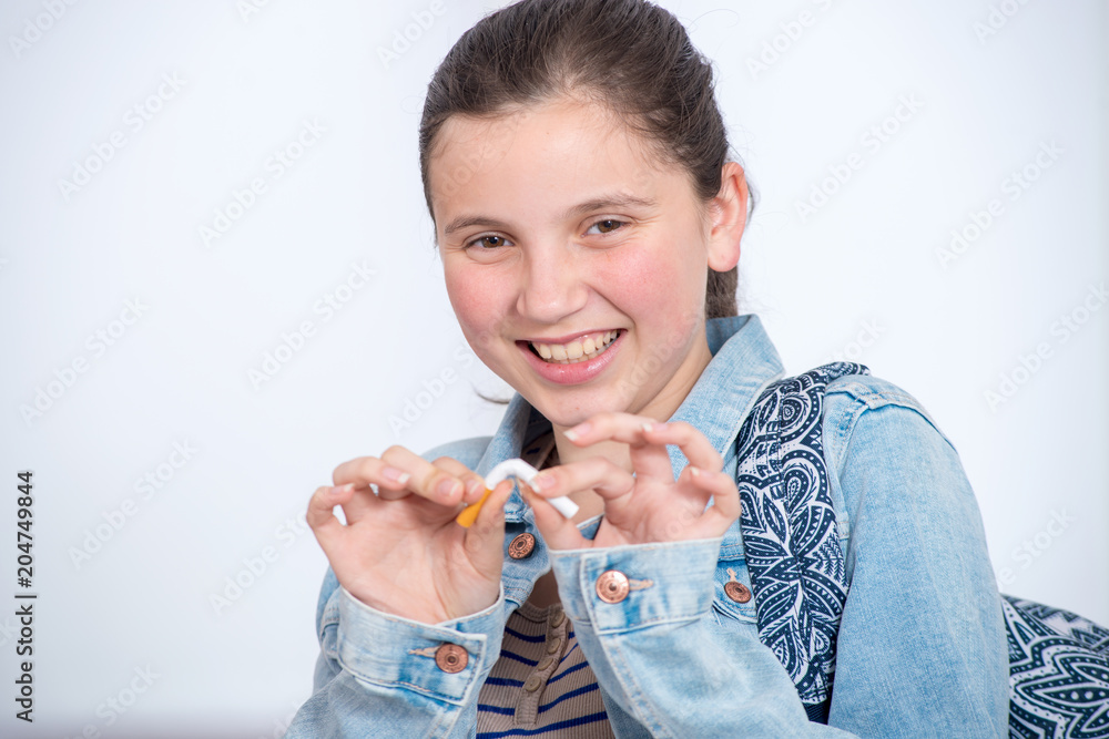 © Philipimage - happy young teenage girl breaking cigarette © Philipimage - happy young teenage girl breaking cigarette