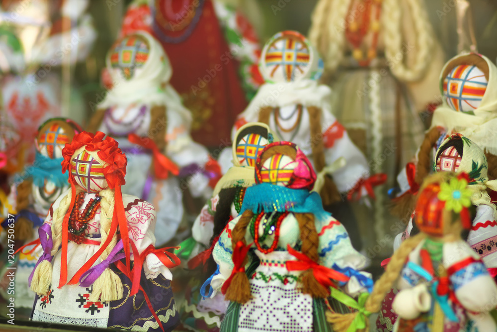 Motankas - traditional ukrainian dolls on display in toy shop window. Symbol of fertility and household guardians,they have no faces to let children develop imagination
