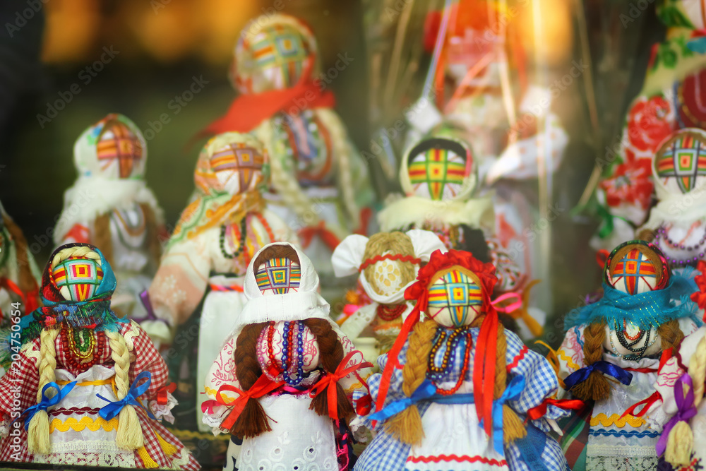Motankas - traditional ukrainian dolls on display in toy shop window. Symbol of fertility and household guardians,they have no faces to let children develop imagination Motankas - traditional ukrainian dolls on display in toy shop window. Symbol of fertility and household guardians,they have no faces to let children develop imagination