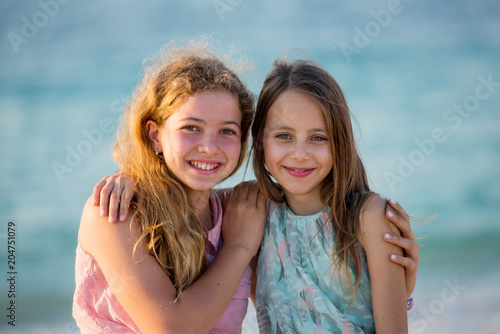 Two young girl friends on the beach