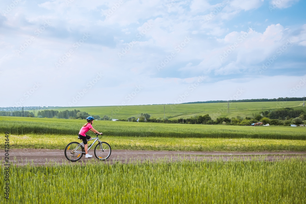 girl on a bicycle in rural landscape girl on a bicycle in rural landscape