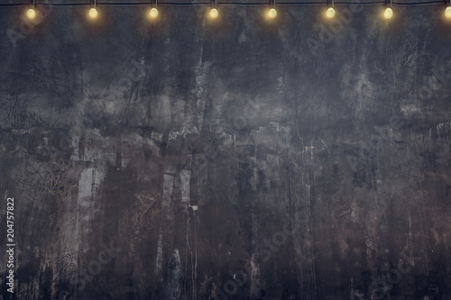 Empty old rustic grunge concrete wall with light bulb string party background,Mock up for display or montage of product or design