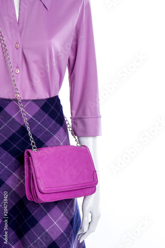 Female mannequin in elegant outfit. Blouse, skirt and fashion clutch for ladies, copy space. Feminine fashion look.