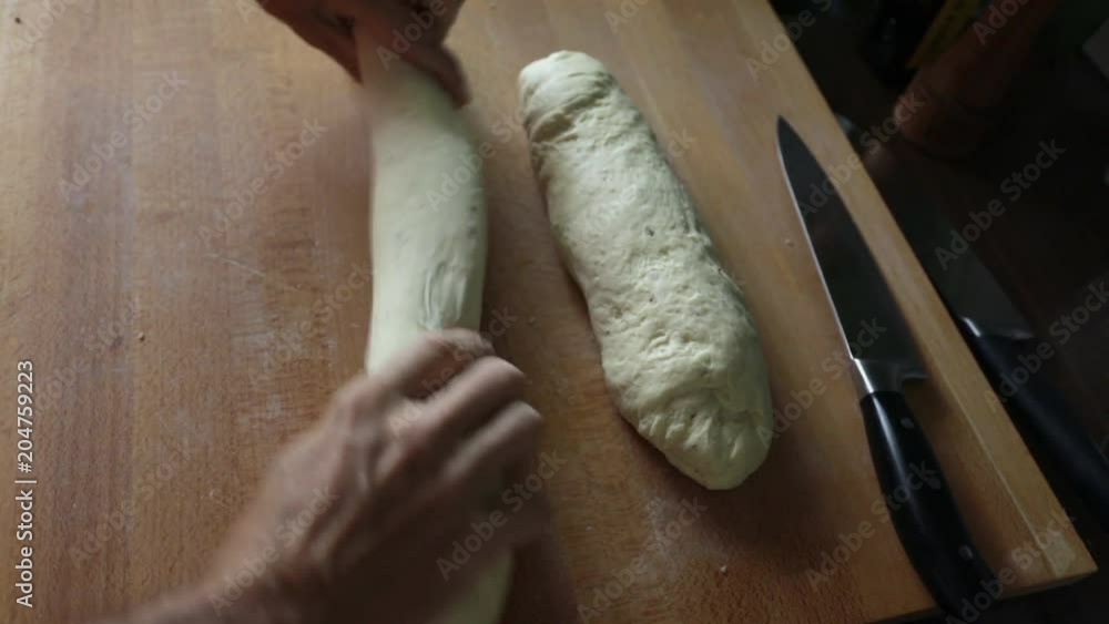 Man kneading bread loaf, close-up at busy hands Man kneading bread loaf, close-up at busy hands