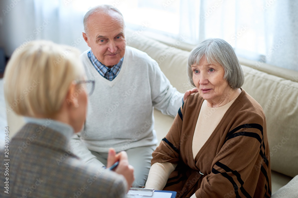 Anonymous therapist having meeting with elderly patients in nursing home giving consultation. Anonymous therapist having meeting with elderly patients in nursing home giving consultation.