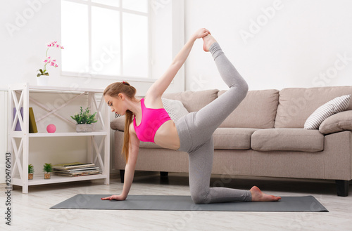Woman training yoga in side plank pose