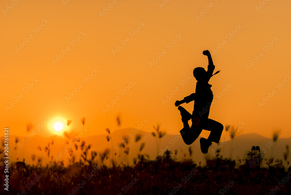 Happy woman jumping and sunset silhouette with copy space. Happy woman jumping and sunset silhouette with copy space.