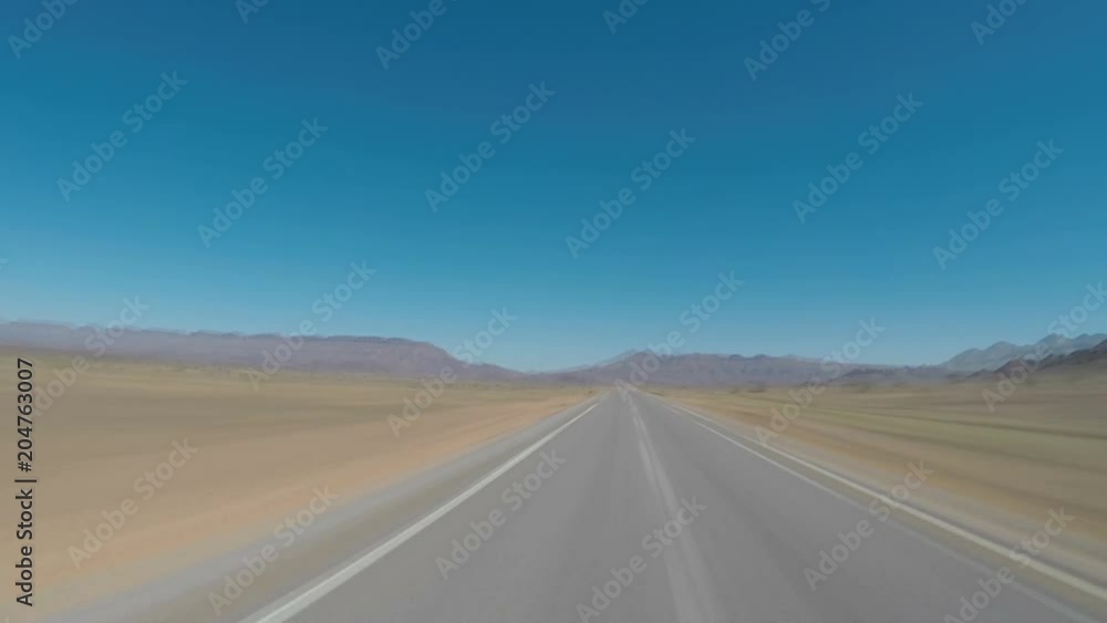 Seamless looping motion blure POV driving shot on an empty road in northern Africa, Morocco