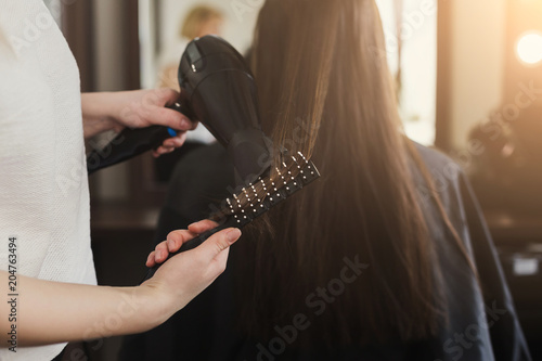 Beautician drying woman's hair