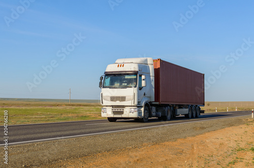Front view of Semi-Truck with Cargo Trailer Driving on a Highway.