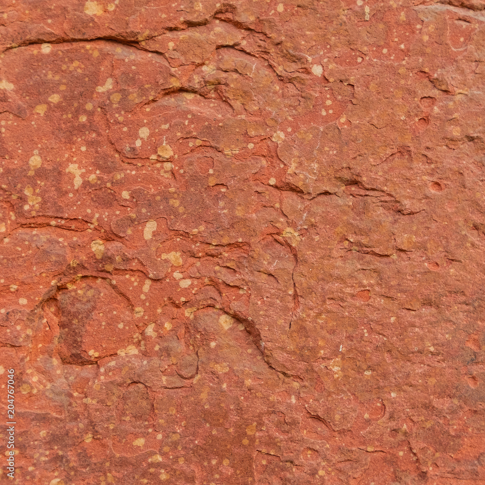 Fototapeta premium Red rough stone texture background. Material construction and architectural detail.