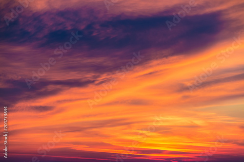 Beautiful cloudscape at scarlet sunset with colorful contrasting cirrus clouds   © dr_verner