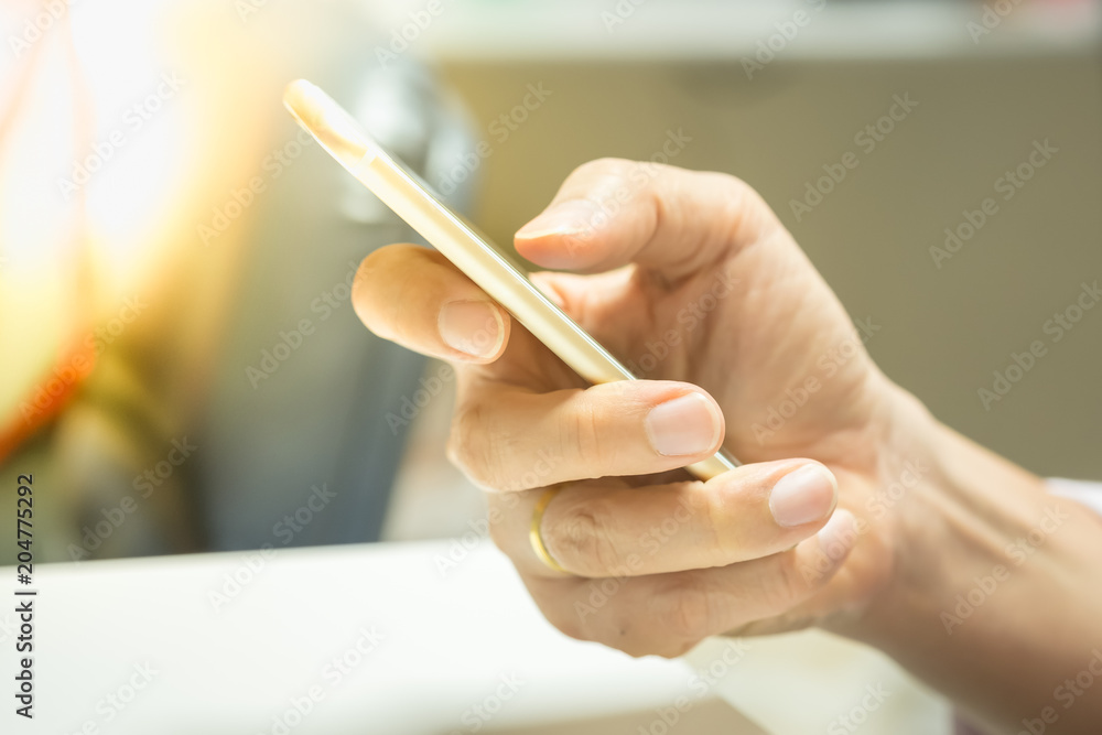 Close up of man hand using smart phone in office. Close up of man hand using smart phone in office.