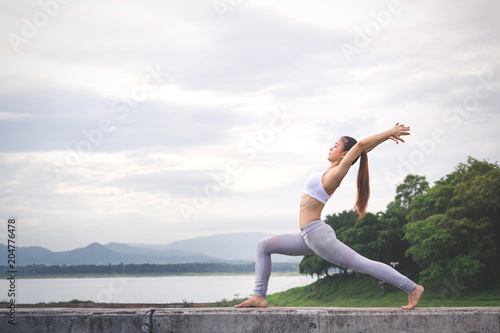 Asia woman doing yoga fitness exercise © Peera