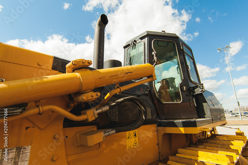 Excavator Loader Machine. Side View of Front Hoe Loader. Industrial Vehicle. Heavy Equipment Machine. Pneumatic Truck. Construction Equipment on a background of blue sky © evgeniykleymenov