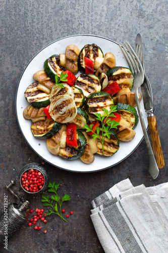 Salad with grilled vegetables and mushrooms. Vegetable salad with grilled champignons. Grilled salad on plate