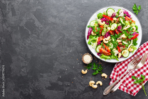 Vegetable salad. Fresh salad with vegetables and nuts. Vegetable salad on plate. Healthy vegetarian food