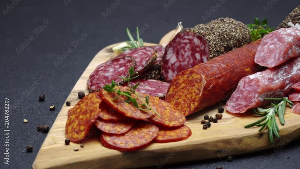 salami and chorizo sausage close up on dark concrete background salami and chorizo sausage close up on dark concrete background