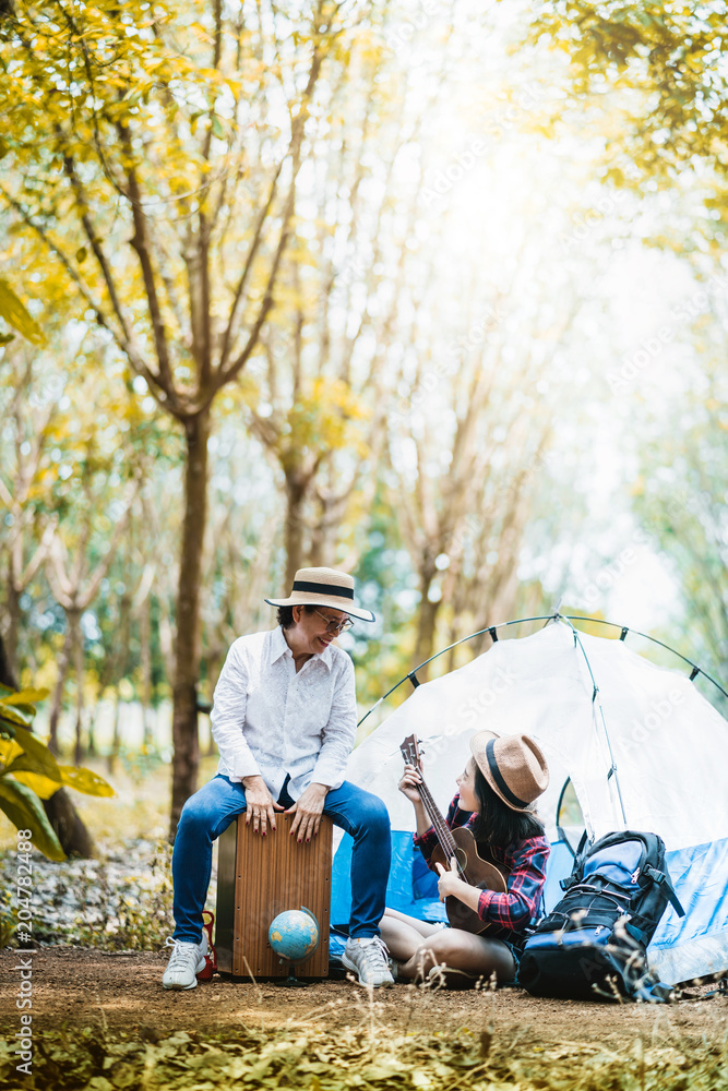 camping concept mom and daughter happy travel together with ukelele and sing in forest autumn landscape background camping concept mom and daughter happy travel together with ukelele and sing in forest autumn landscape background