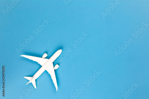 Model plane,airplane on blue pastel color background with copy space.Flat lay design.Travel concept on blue background. top view