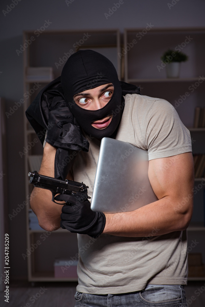 Burglar wearing balaclava mask at crime scene Burglar wearing balaclava mask at crime scene