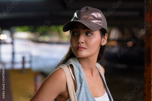 Young beautiful Asian tourist woman exploring the city of Bangko photo