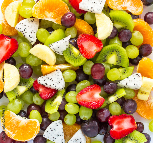 Healthy fresh fruit salad on white background. Top view.Fruit background
