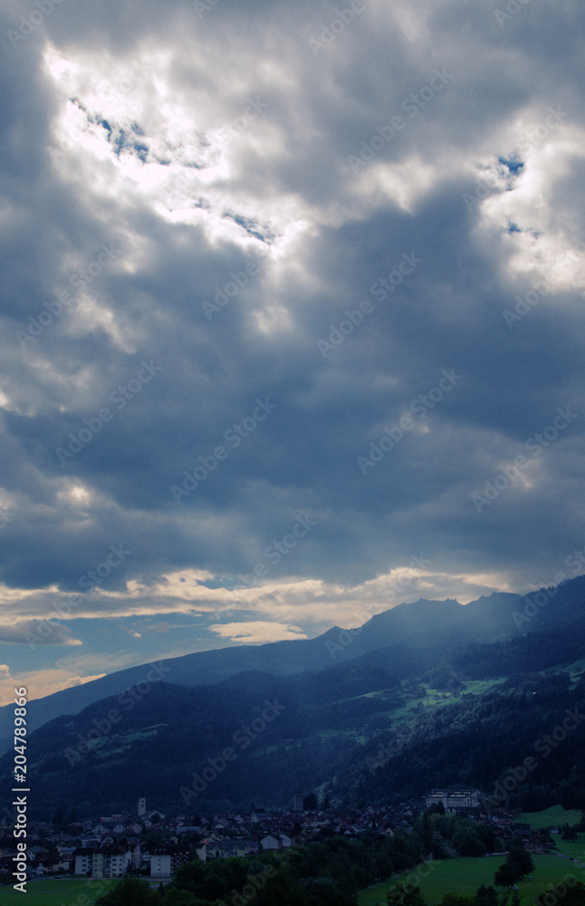 Obraz premium Stormy sky and sunbeam over Flums, Swiss Alps