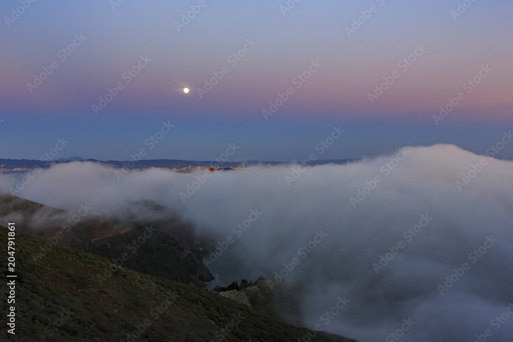 Night moon rise and sea cloud of the famous and beautiful Golden Gate Bridge