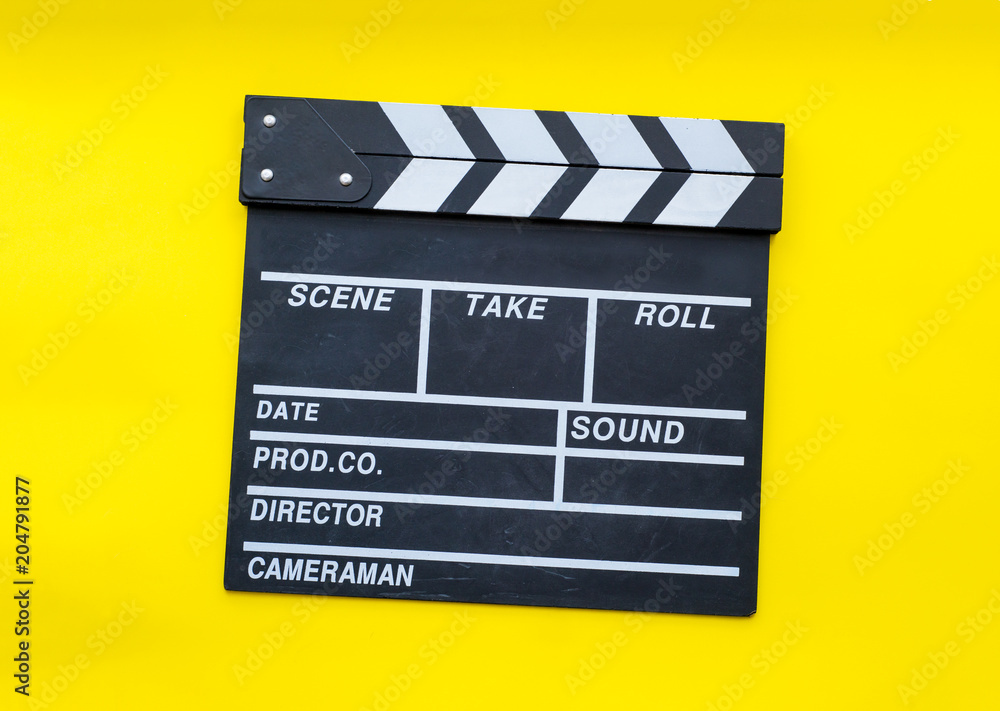 Movie clapperboard on yellow background