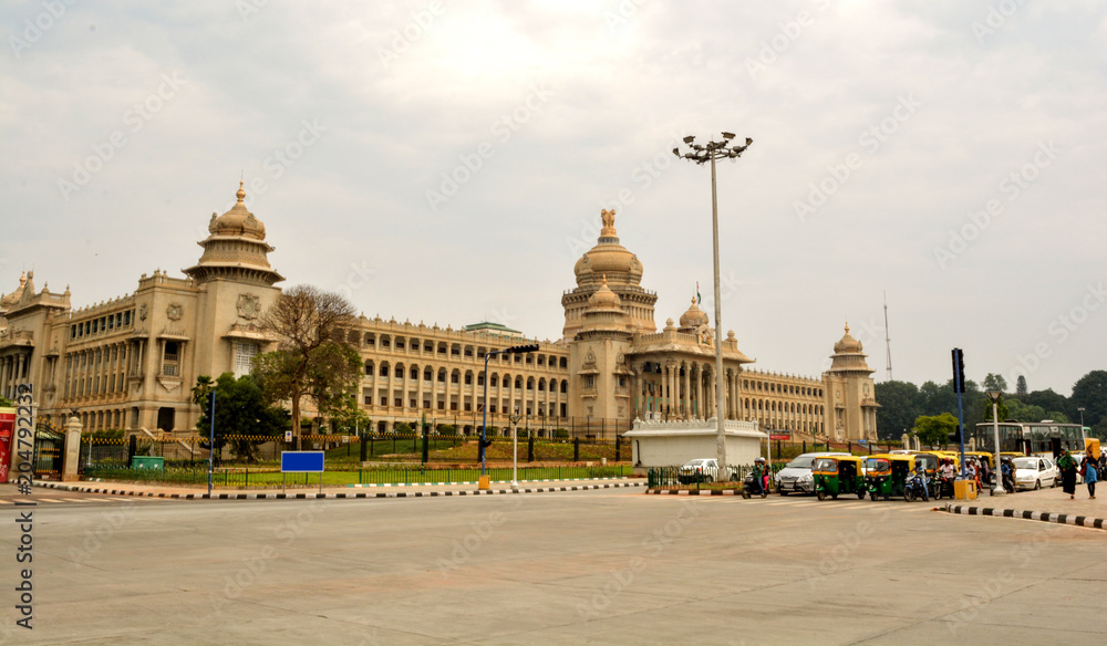 vehicles wating of traffic signl in front of Vidhana Soudha the state legislature building in Bangalore, India