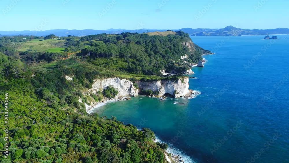 Aerial view of white cliffs and beaches of Cathedral Cove - South Pacific Ocean shore, Coromandel Peninsula, North Island, New Zealand from above, 4k UHD Aerial view of white cliffs and beaches of Cathedral Cove - South Pacific Ocean shore, Coromandel Peninsula, North Island, New Zealand from above, 4k UHD