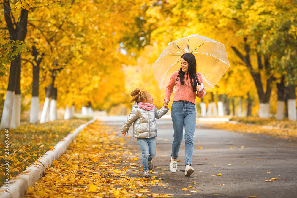 Cheerful girls walking the autumn park togrther Cheerful girls walking the autumn park togrther