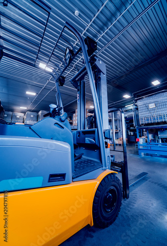 Forklift loader. Pallet stacker truck equipment at warehouse