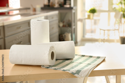 Rolls of paper towels and dishcloth on table indoors