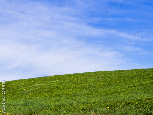 Rolling hill green hill, with dreamy clouds and blue sky in the background. Looks similar to the legendary default wallpaper in an old operating system. What a bliss to behold.. 