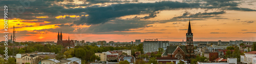Фотография beautiful view of the evening city under the dramatic sky at sunset time