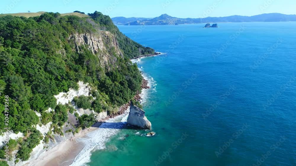 Aerial view of white cliffs and beaches of Cathedral Cove - South Pacific Ocean shore, Coromandel Peninsula, North Island, New Zealand from above, 4k UHD Aerial view of white cliffs and beaches of Cathedral Cove - South Pacific Ocean shore, Coromandel Peninsula, North Island, New Zealand from above, 4k UHD