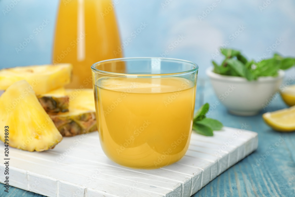 Glass with delicious pineapple juice on table Glass with delicious pineapple juice on table
