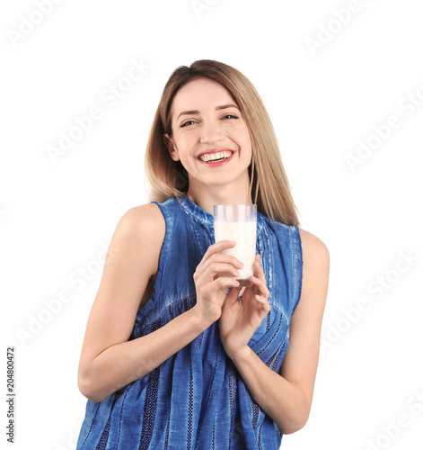 Beautiful young woman drinking milk on white background