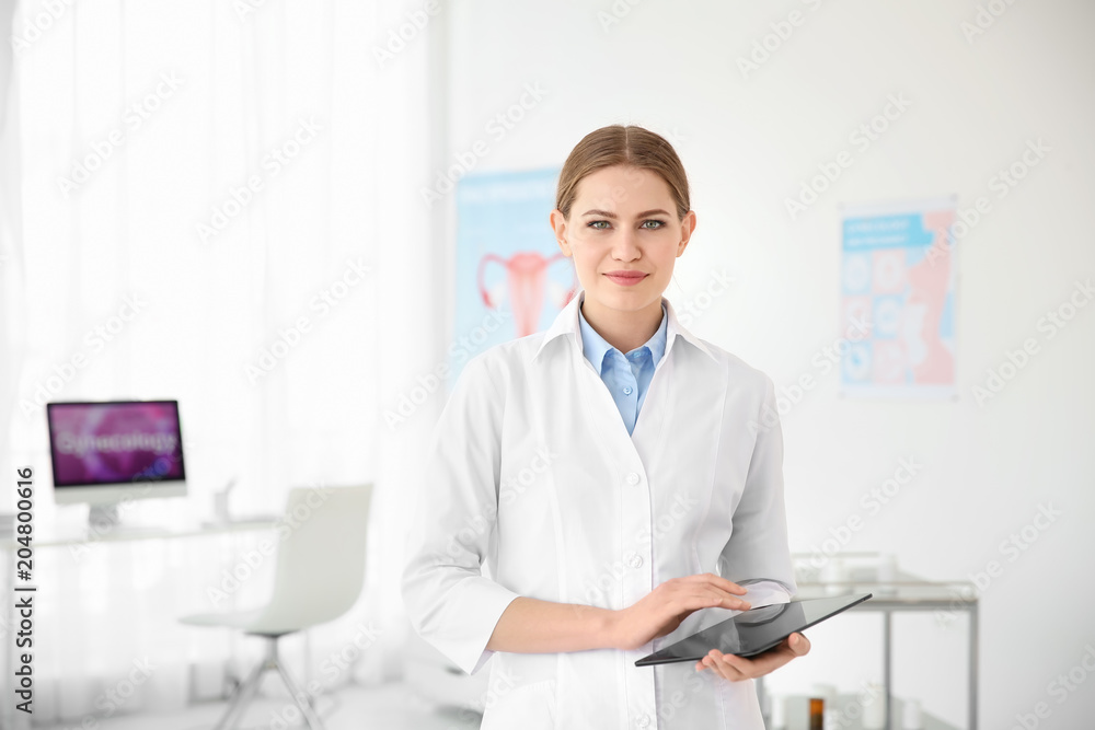 Young female doctor with tablet in modern hospital. Gynecology consultation Young female doctor with tablet in modern hospital. Gynecology consultation