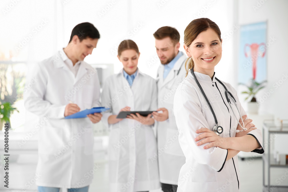 Smiling female doctor wearing uniform in modern hospital. Gynecology department Smiling female doctor wearing uniform in modern hospital. Gynecology department