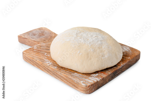 Wooden board with raw dough on white background photo