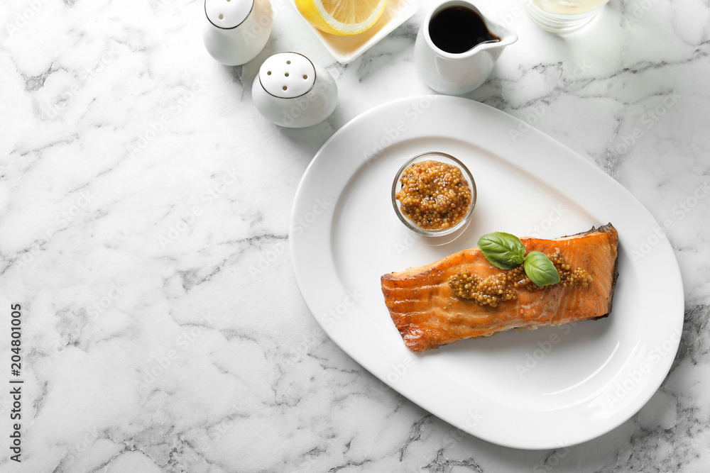 Tasty cooked salmon with mustard on plate, top view Tasty cooked salmon with mustard on plate, top view