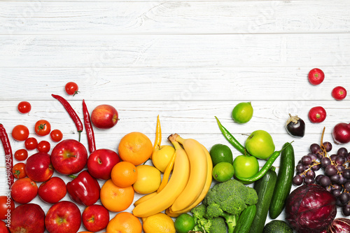 Fototapeta Naklejka Na Ścianę i Meble -  Rainbow composition with fresh vegetables and fruits on wooden background, flat lay