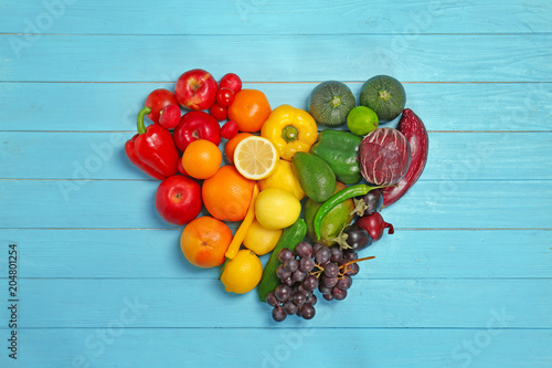 Fototapeta Naklejka Na Ścianę i Meble -  Rainbow heart made of fruits and vegetables on wooden background