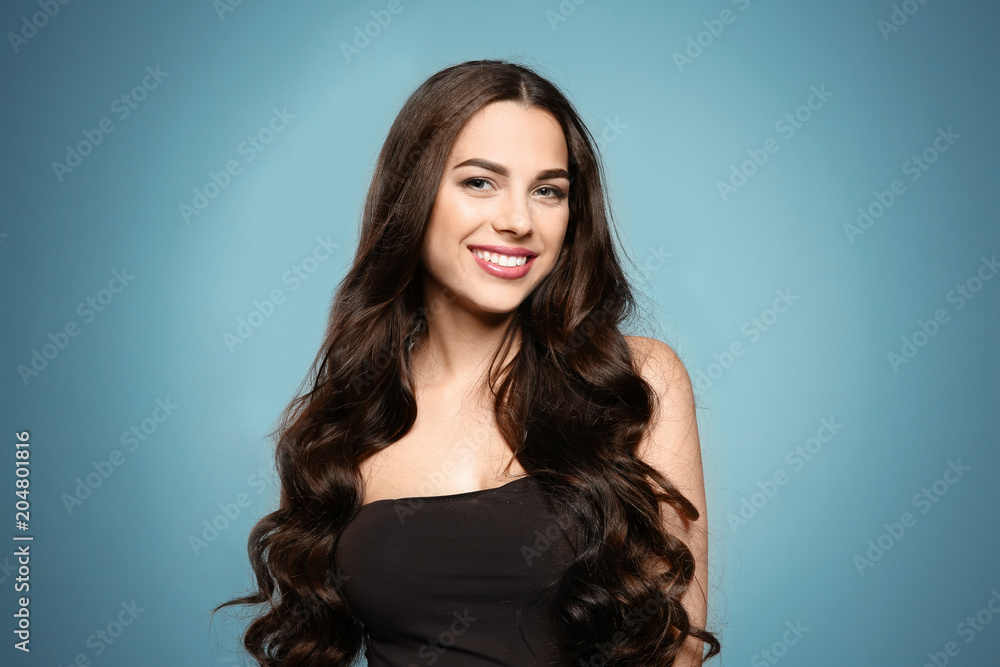 Portrait of beautiful model with gorgeous curly hair on color background Portrait of beautiful model with gorgeous curly hair on color background