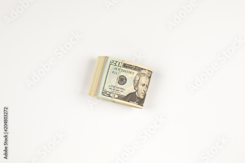 Stack of USA 20 dollars isolated on white background.