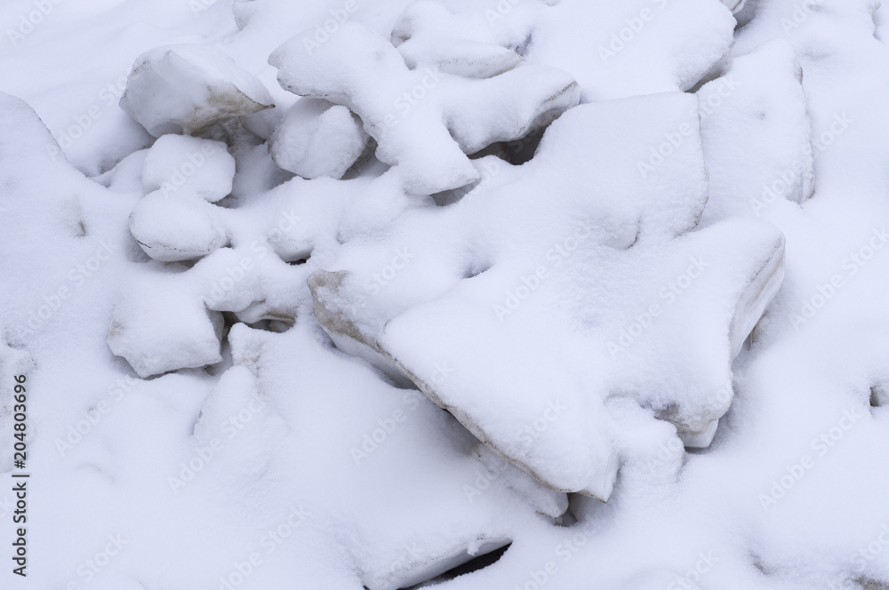 pile of melting ice blocks cowered with snow. seasonal, background, nature.